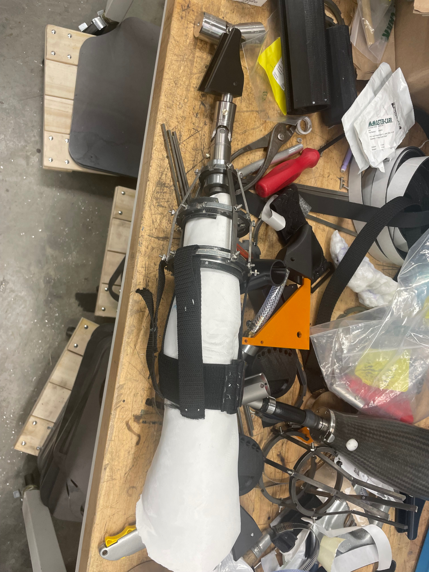 Adaptive golf prosthetic prototype mounted on a residual-limb model on the workbench.